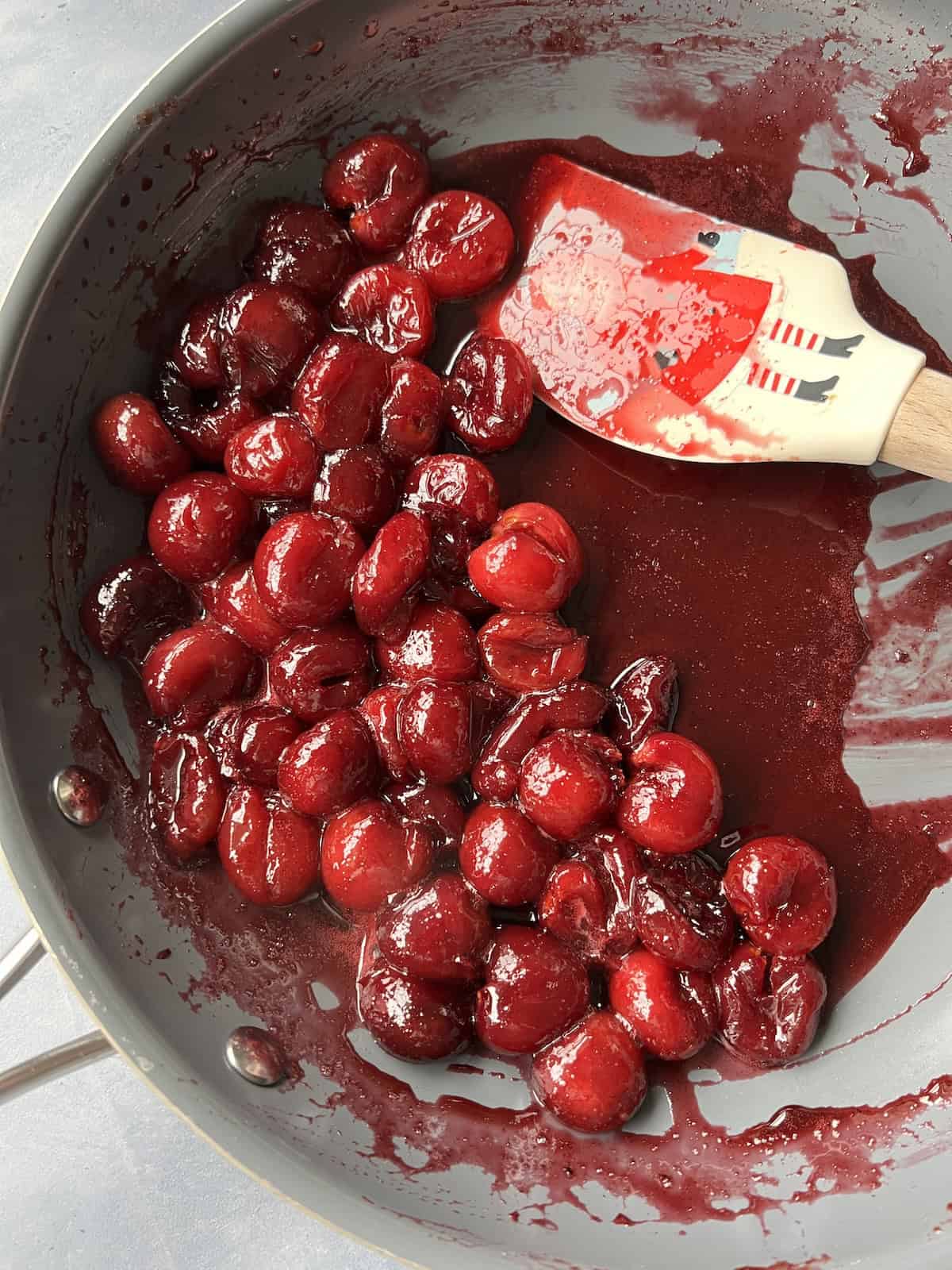 the bourbon has been cooked into the cherry mixture, leaving a deeply colored and lightly thickened cherry mixture. 