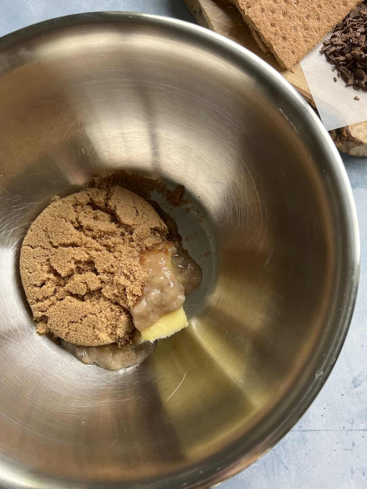 butter, mashed banana, and brown sugar in a stainless steel mixing bowl. 