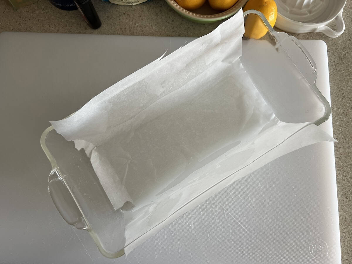 a glass loaf pan lightly sprayed with cooking oil and then lined with a sheet of parchment paper.