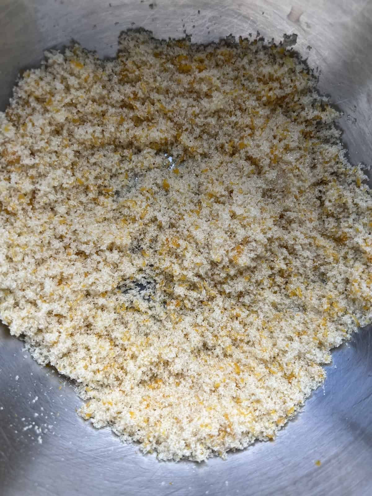 a bowl with granulated sugar and meyer lemon zest mixed together.