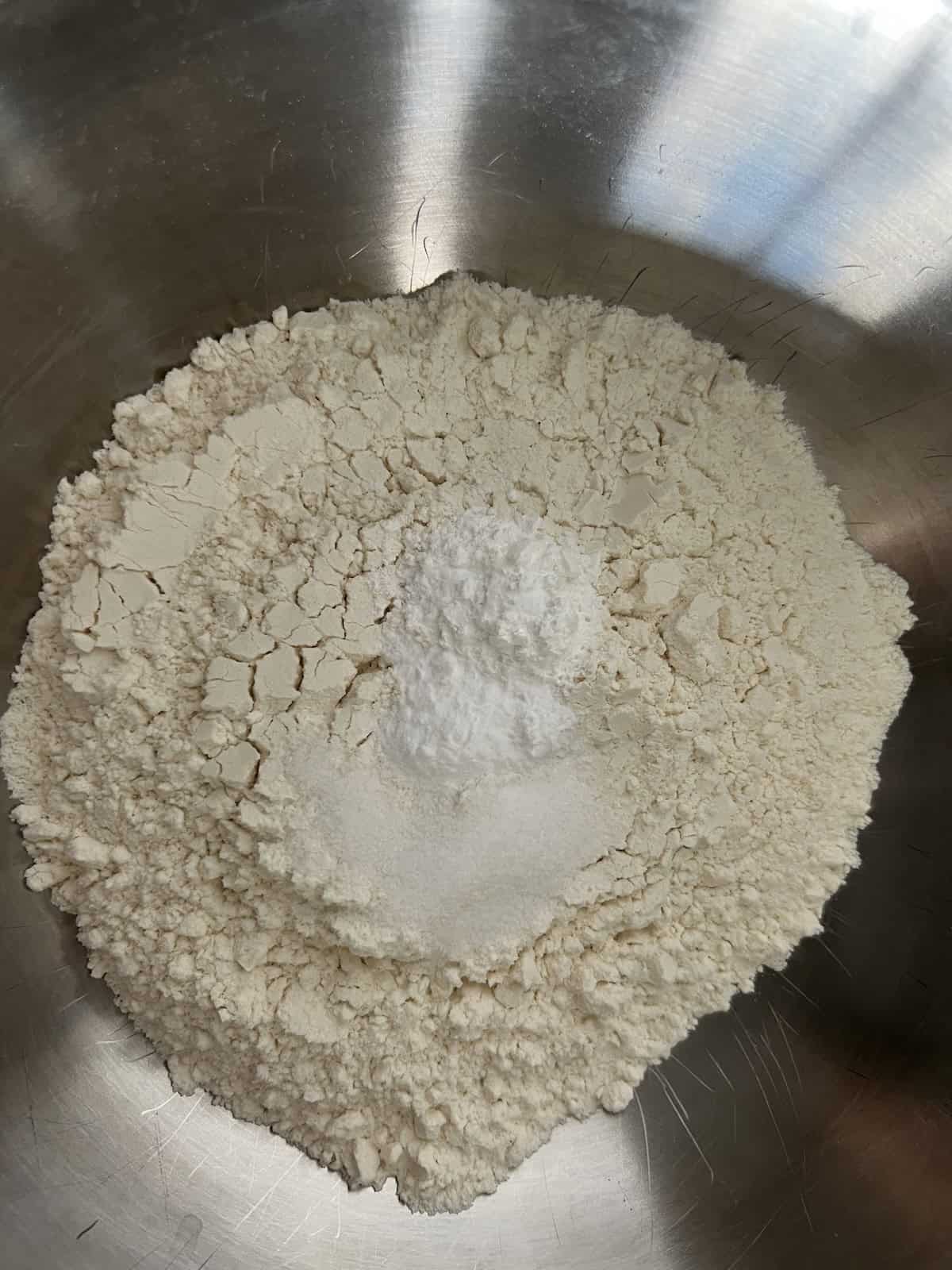 a bowl containing all-purpose flour, baking powder, baking soda, and salt.
