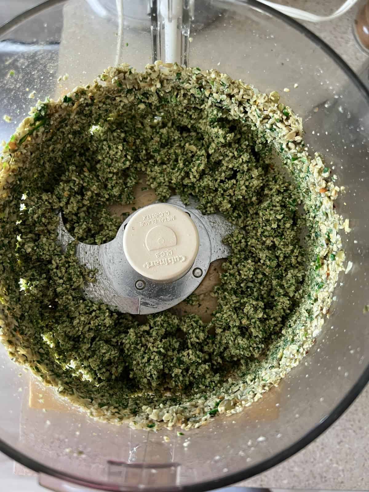 the greens and seasonings are blended into the seed mixture, taking on a thick, paste-like texture