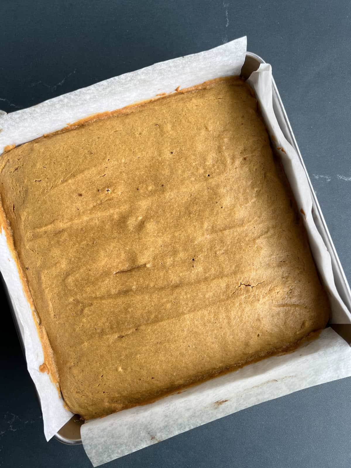 the baked pumpkin spice blondies are firm and slightly darker around the edges