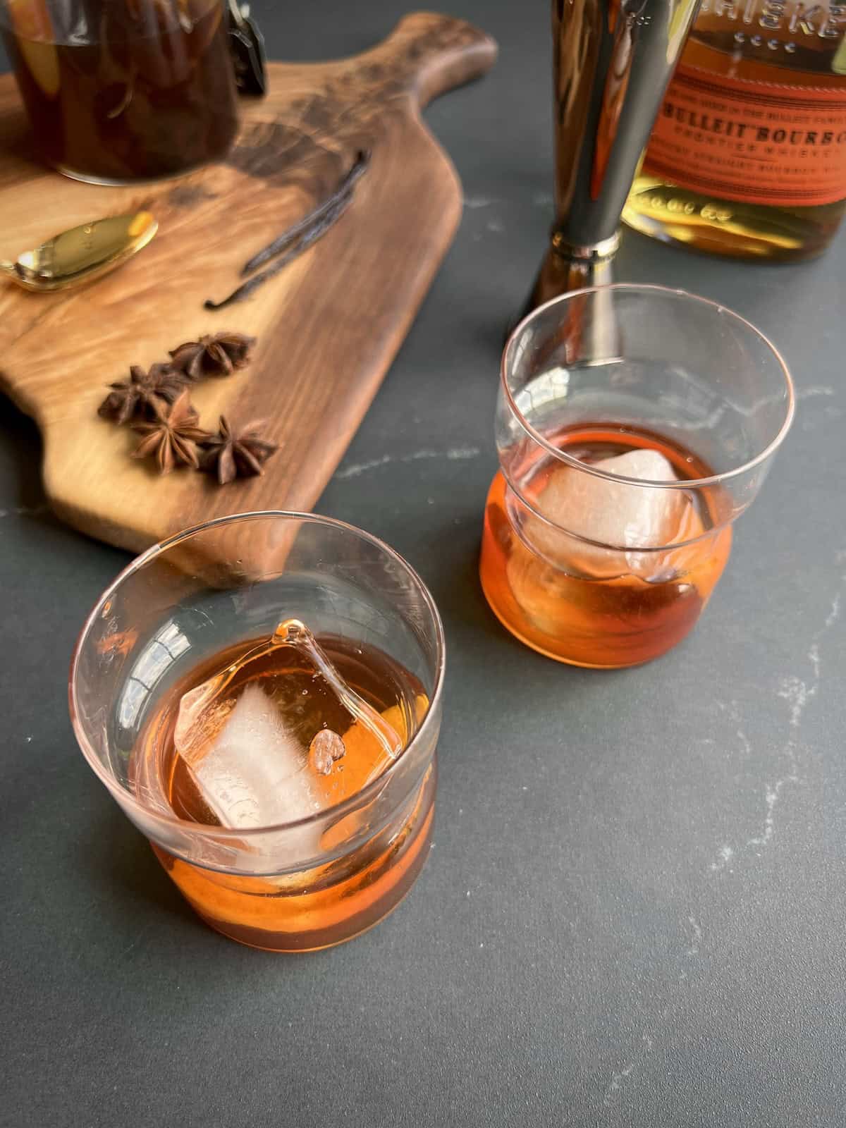 bourbon is poured over the ice into each glass and stirred
