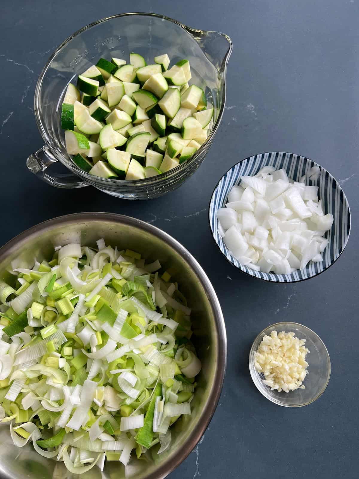 various bowls containing the sliced and chopped vegetables