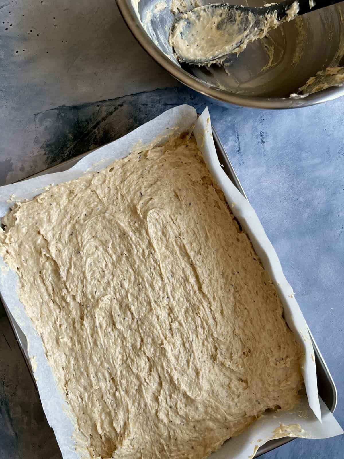 the spiced chai cake batter is transferred to the prepared baking pan