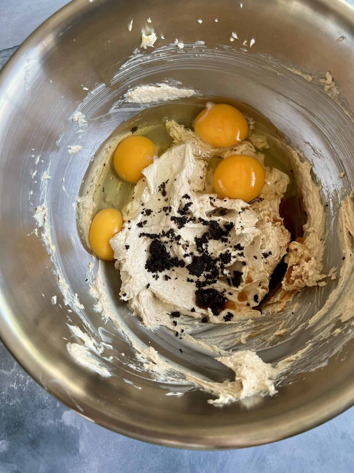 eggs, liquid ingredients, and the contents from a steeped tea bag are added to the bowl with the butter mixture