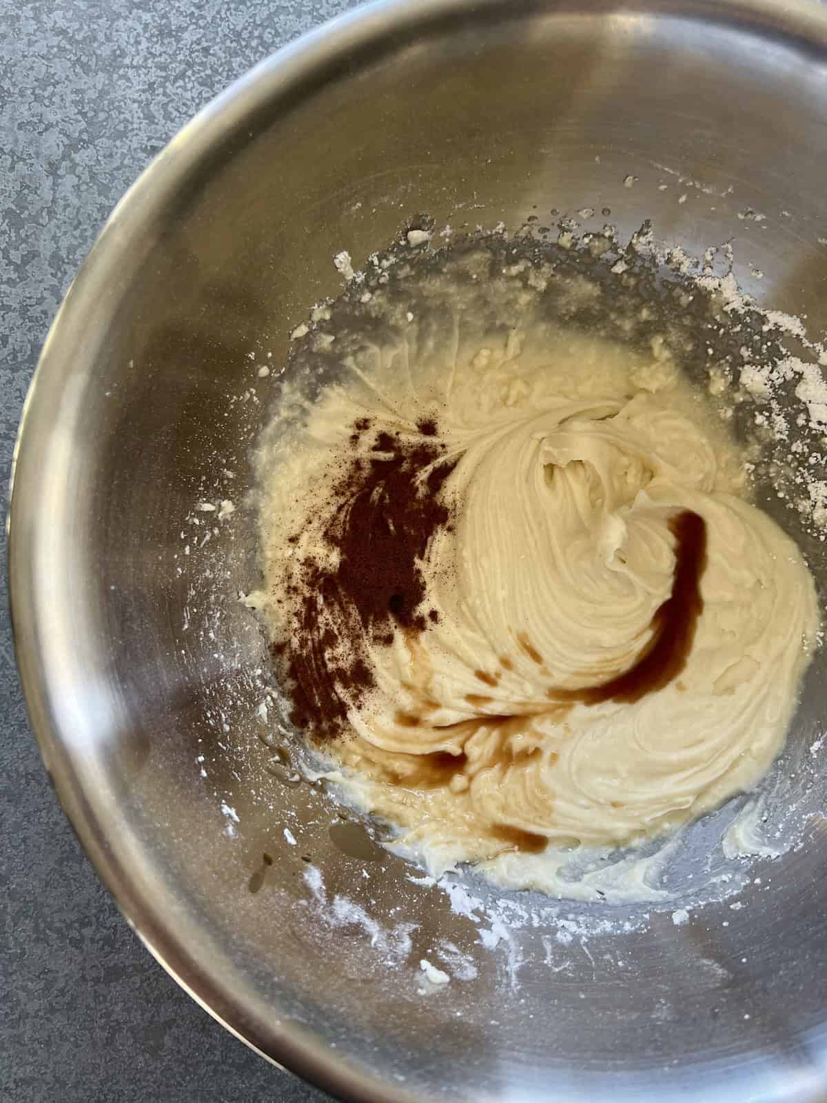 a silky frosting is formed, to which spices and vanilla are added
