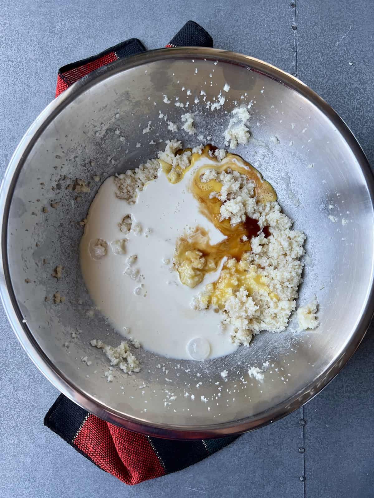 additional liquid and spice ingredients are added to the bowl with the butter mixture.