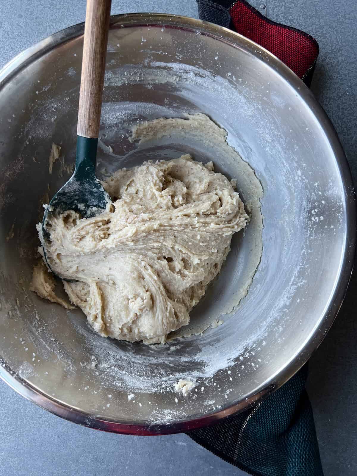 a thick and sticky dough has formed in the mixing bowl