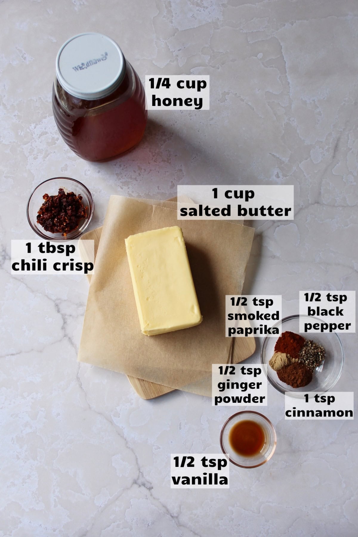 all of the ingredients needed to make hot honey butter are laid out on a work surface and labeled
