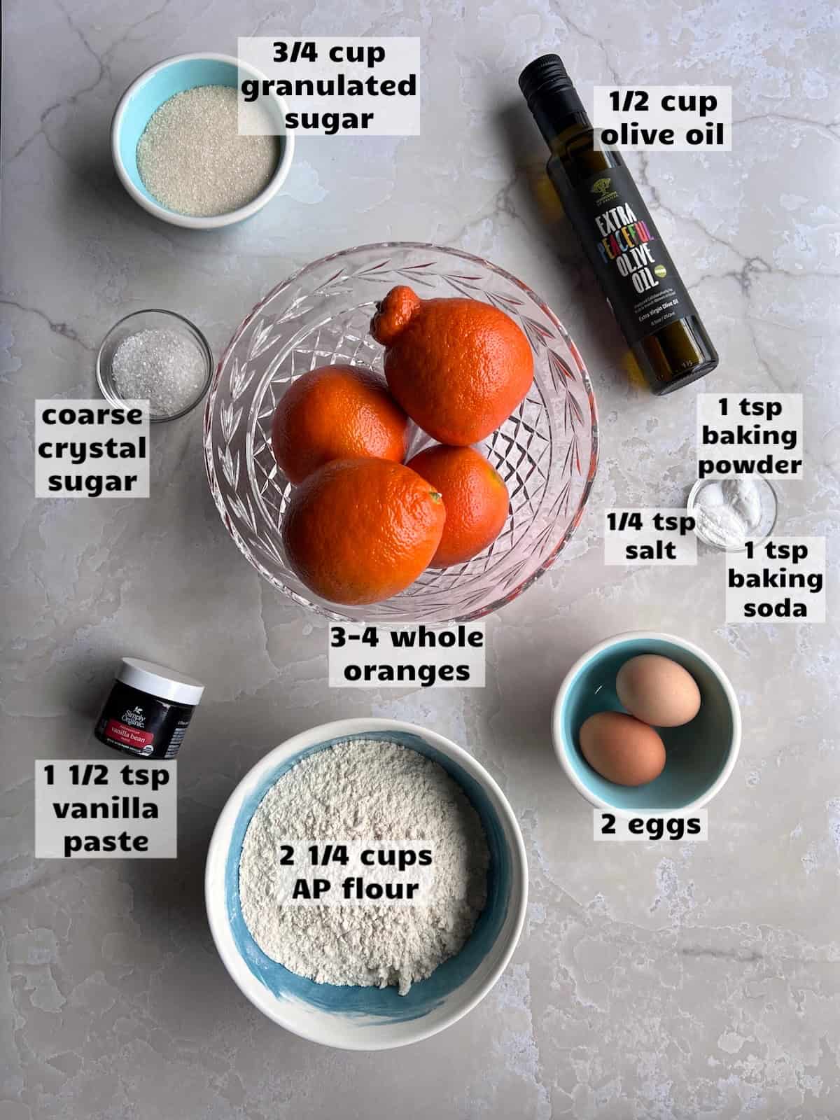 all of the ingredients needed to make this orange muffins recipe are laid out on a work surface and labeled
