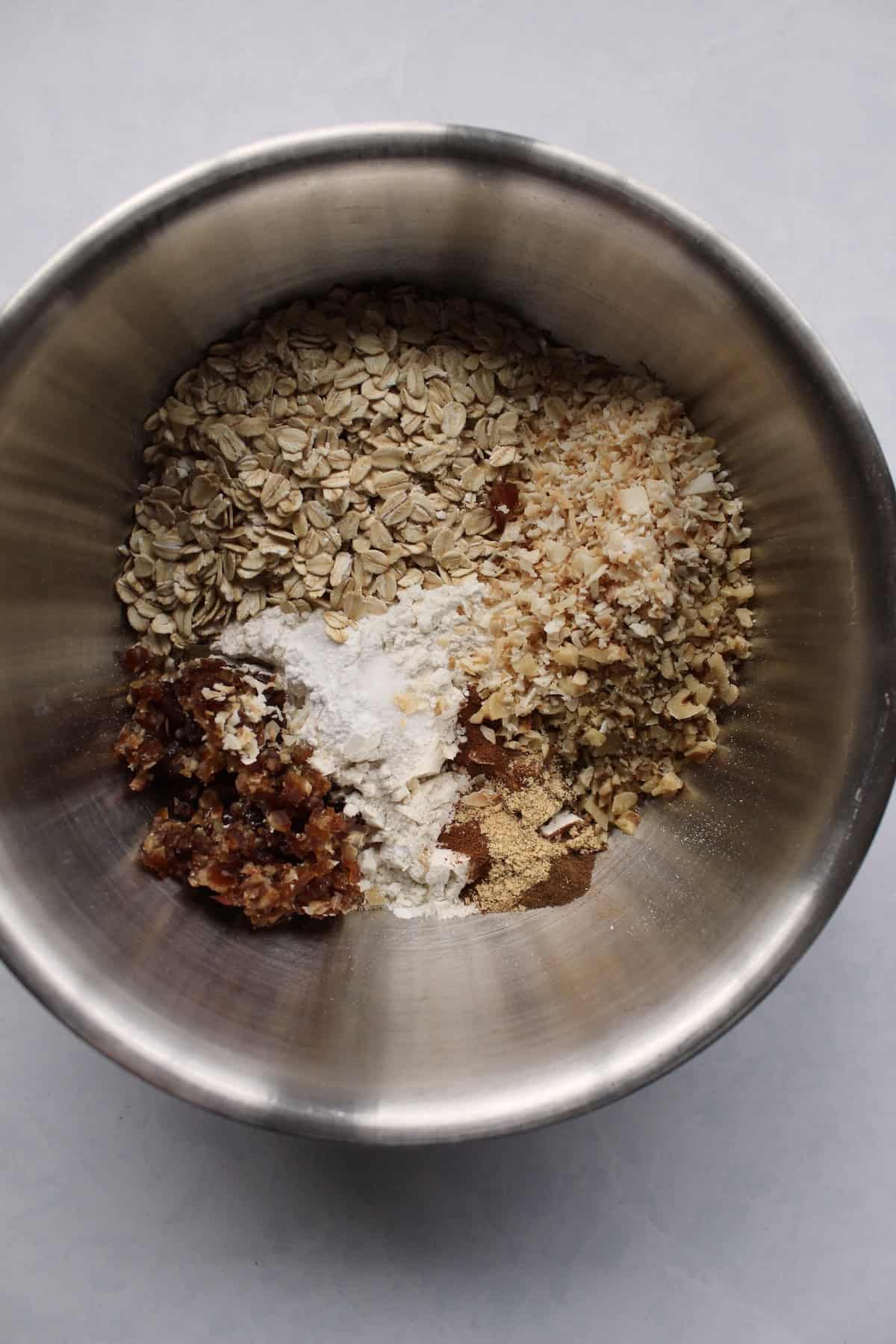 a large mixing bowl containing various dry ingredients