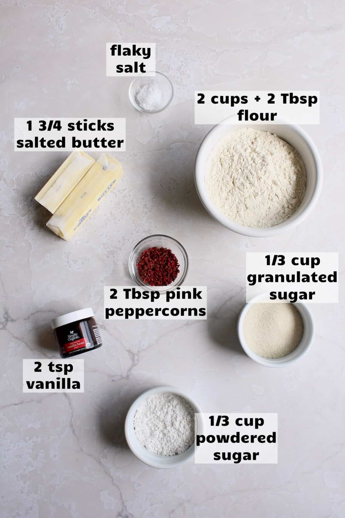 all of the ingredients needed to make pink peppercorn shortbread cookies are laid out on a work surface and labeled