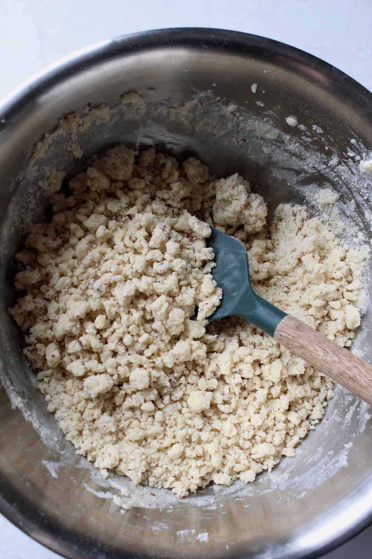 a crumbly, sandy dough comes together in the large mixing bowl
