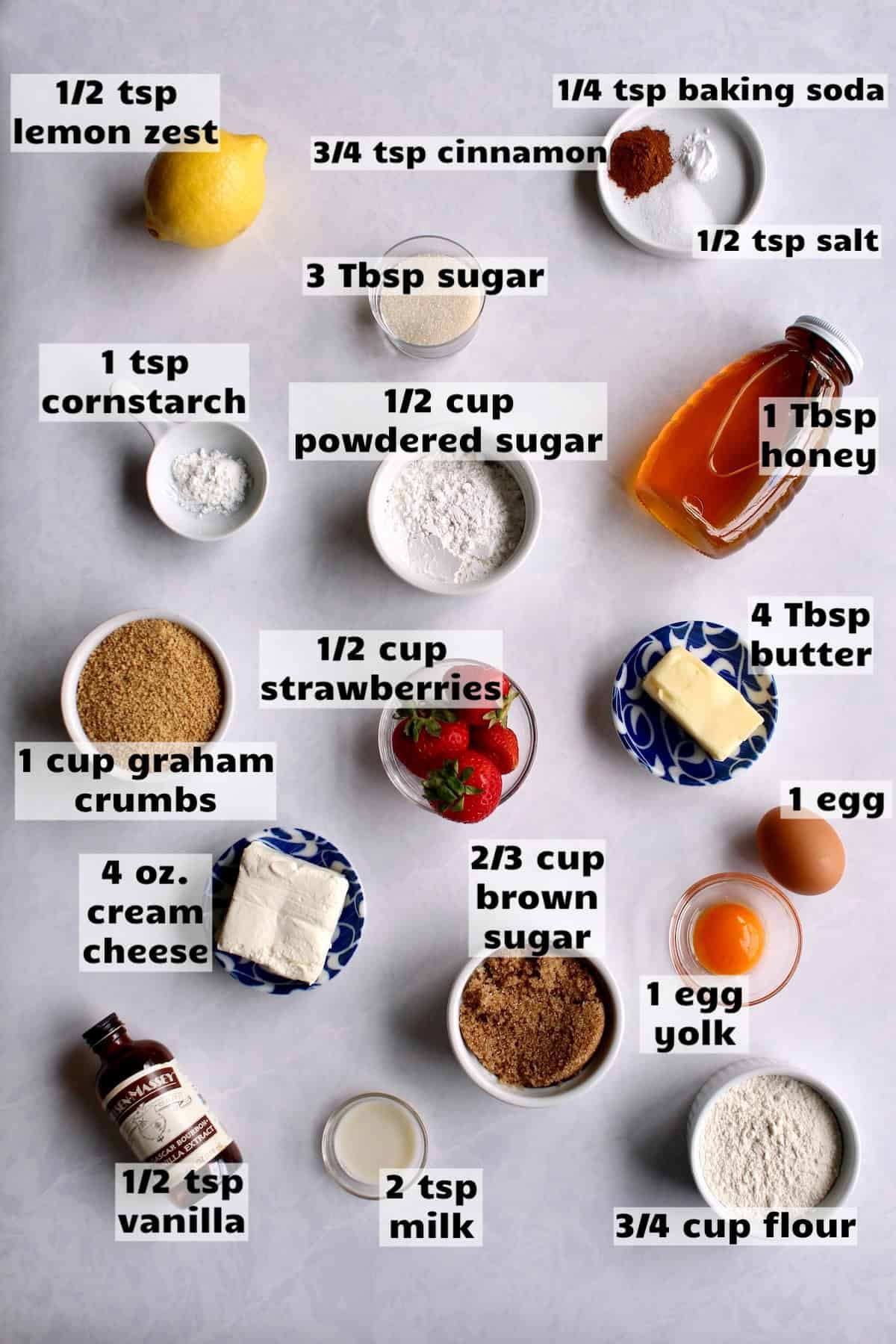 all of the ingredients needed to make this strawberry cheesecake cookies recipe are laid out on a work surface and labeled