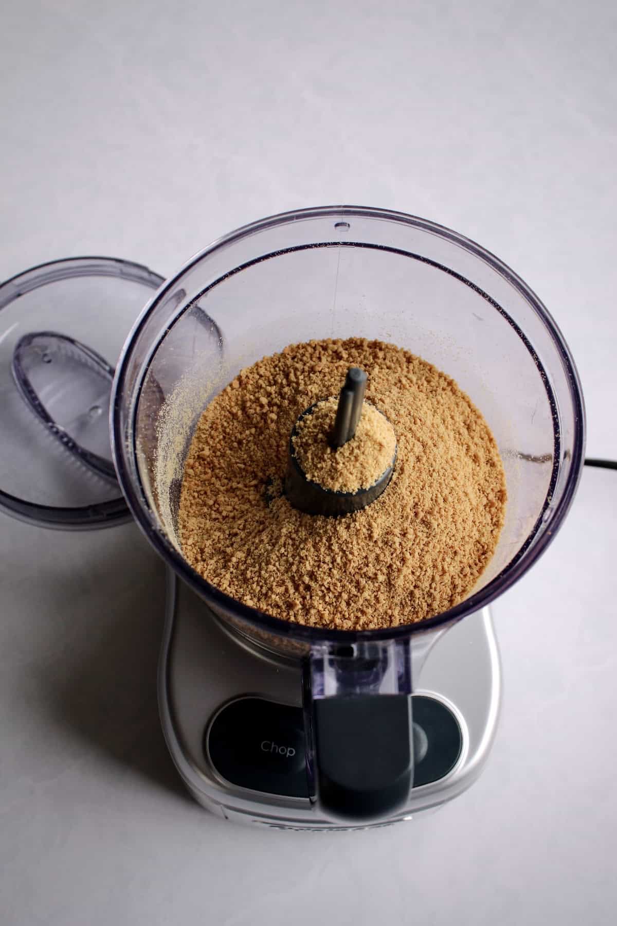 a mini food processor containing graham cracker crumbs.