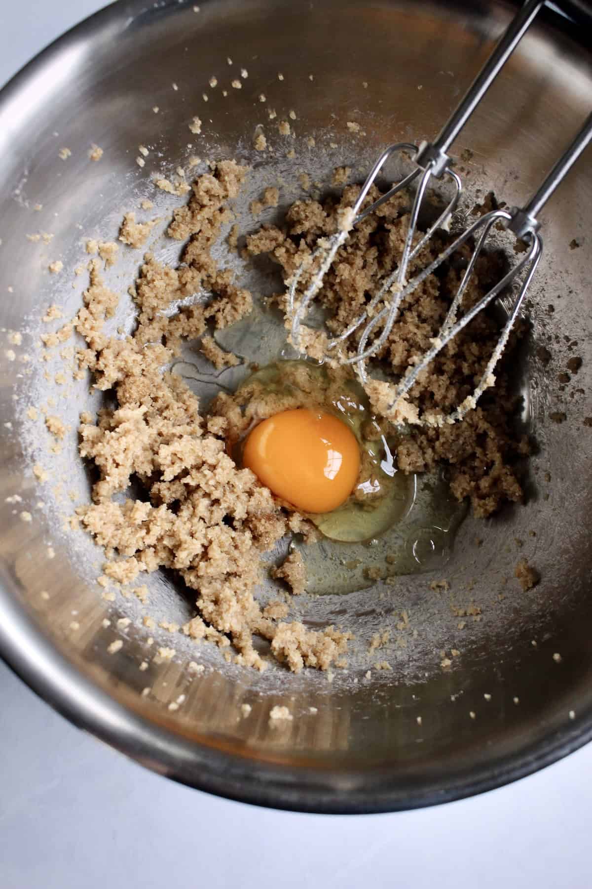 an egg is added to the fluffy butter-sugar mixture.