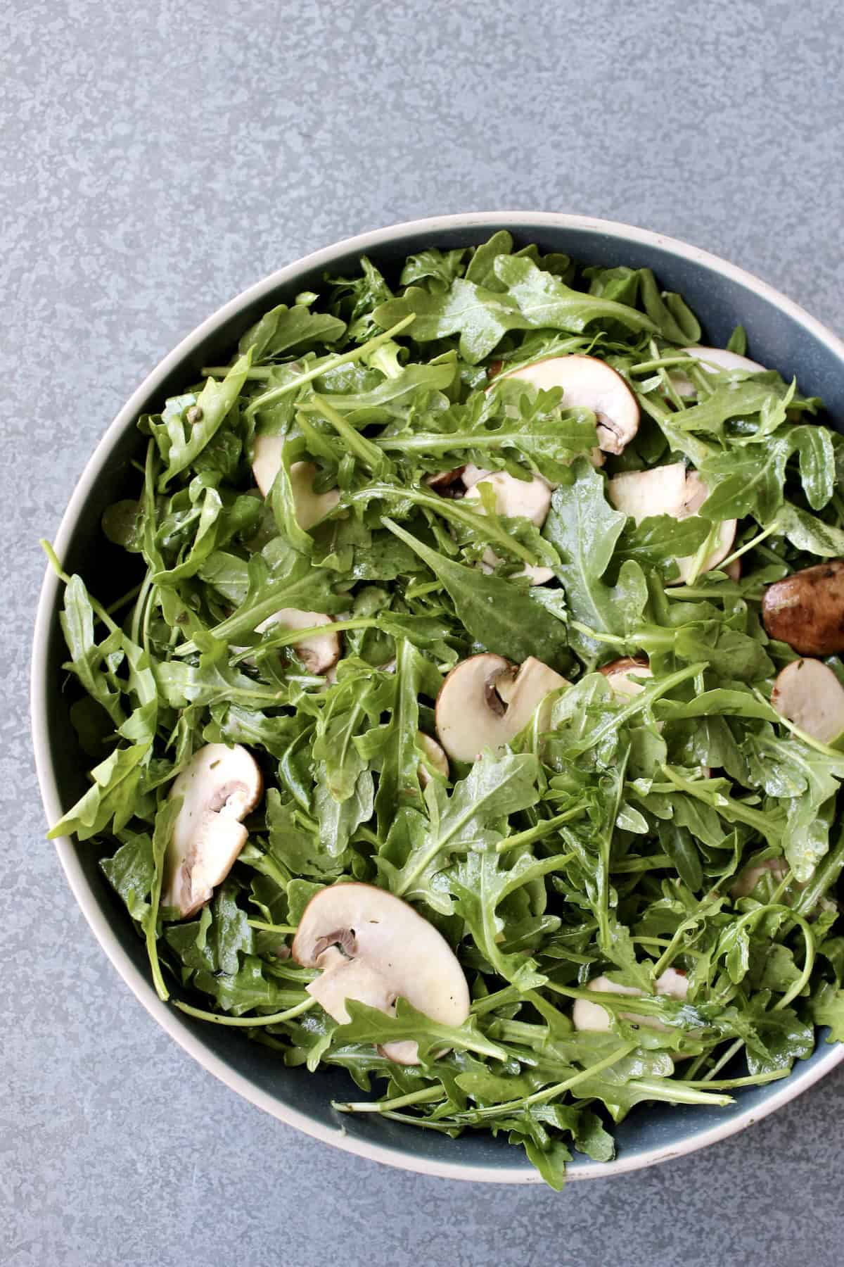 the salad mixture is transferred to a wide stone serving bowl