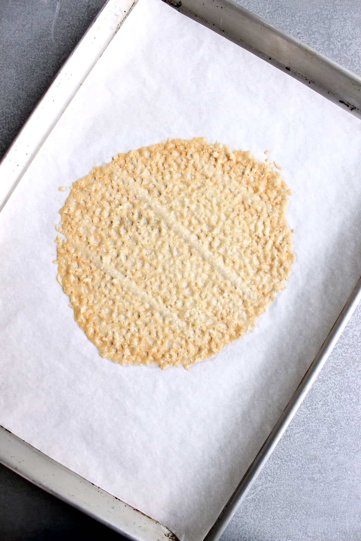 the baked parmesan cheese becomes a golden brown, circular crisp with a lacy texture.