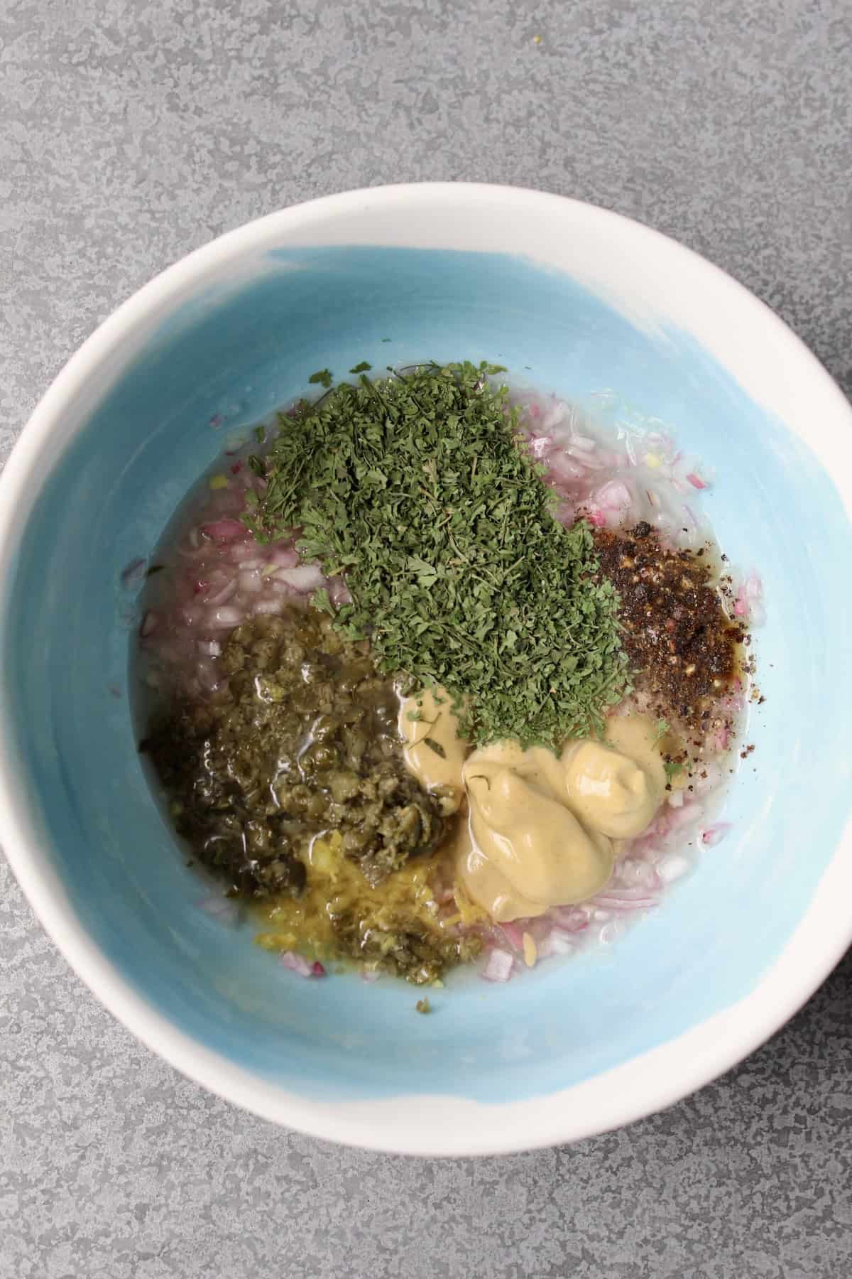 the remaining dressing ingredients are added to the blue mixing bowl