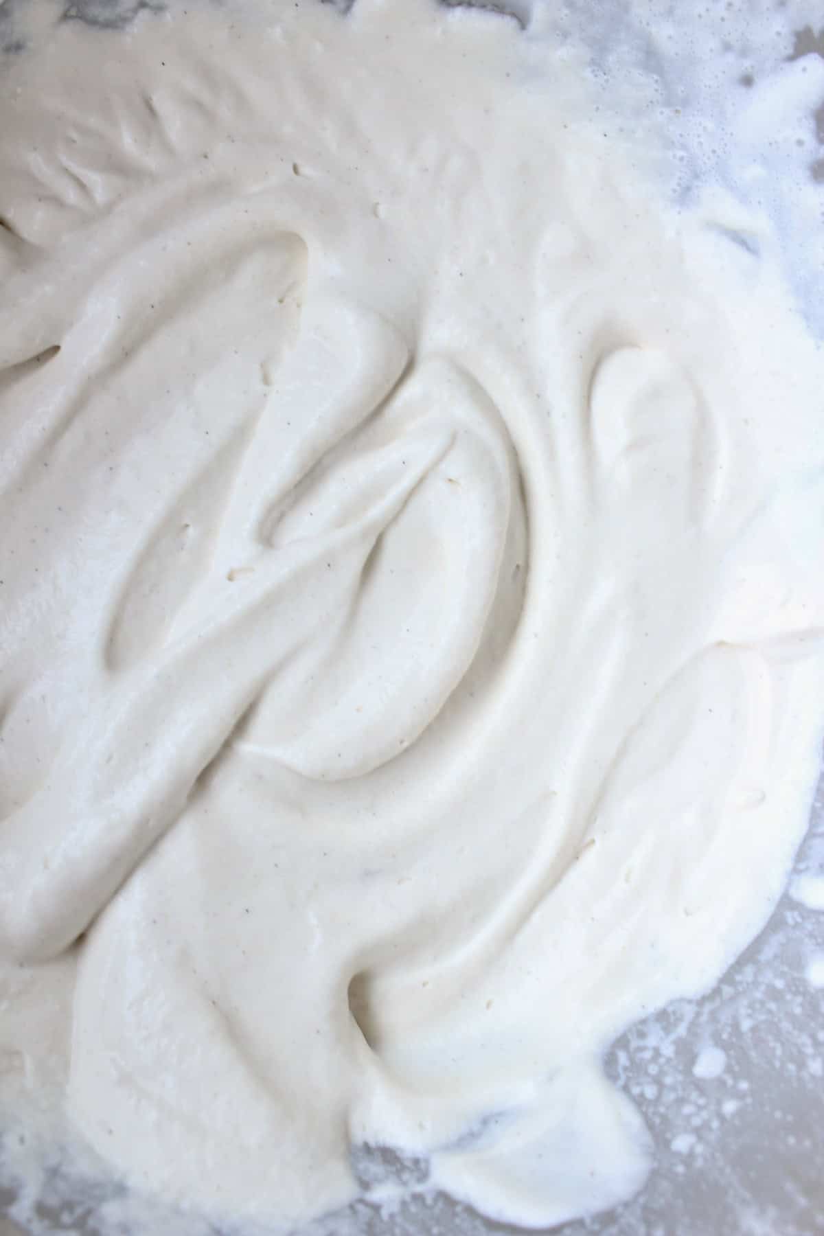 the fully whipped brown sugar whipped cream has soft peaks and flecks of vanilla throughout
