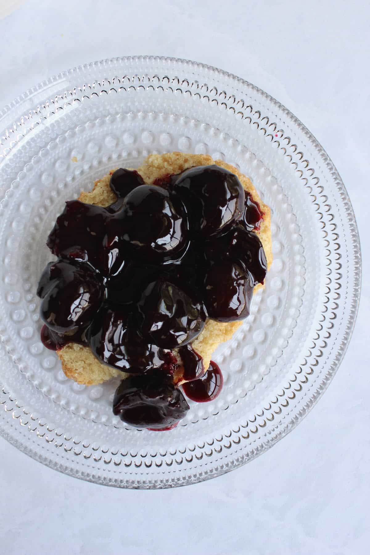richly colored bourbon cherry compote is spooned onto the shortcake half