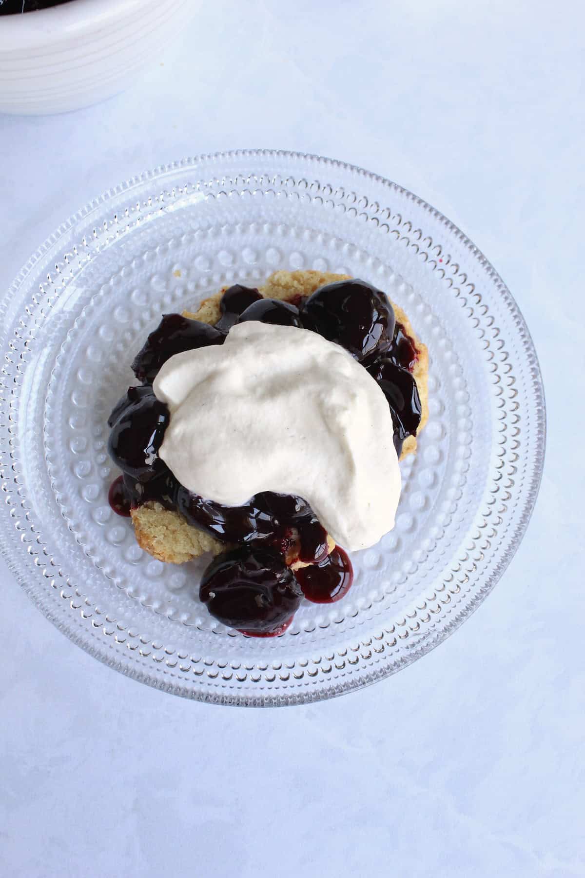 a dollop of brown sugar whipped cream is placed atop the cherries