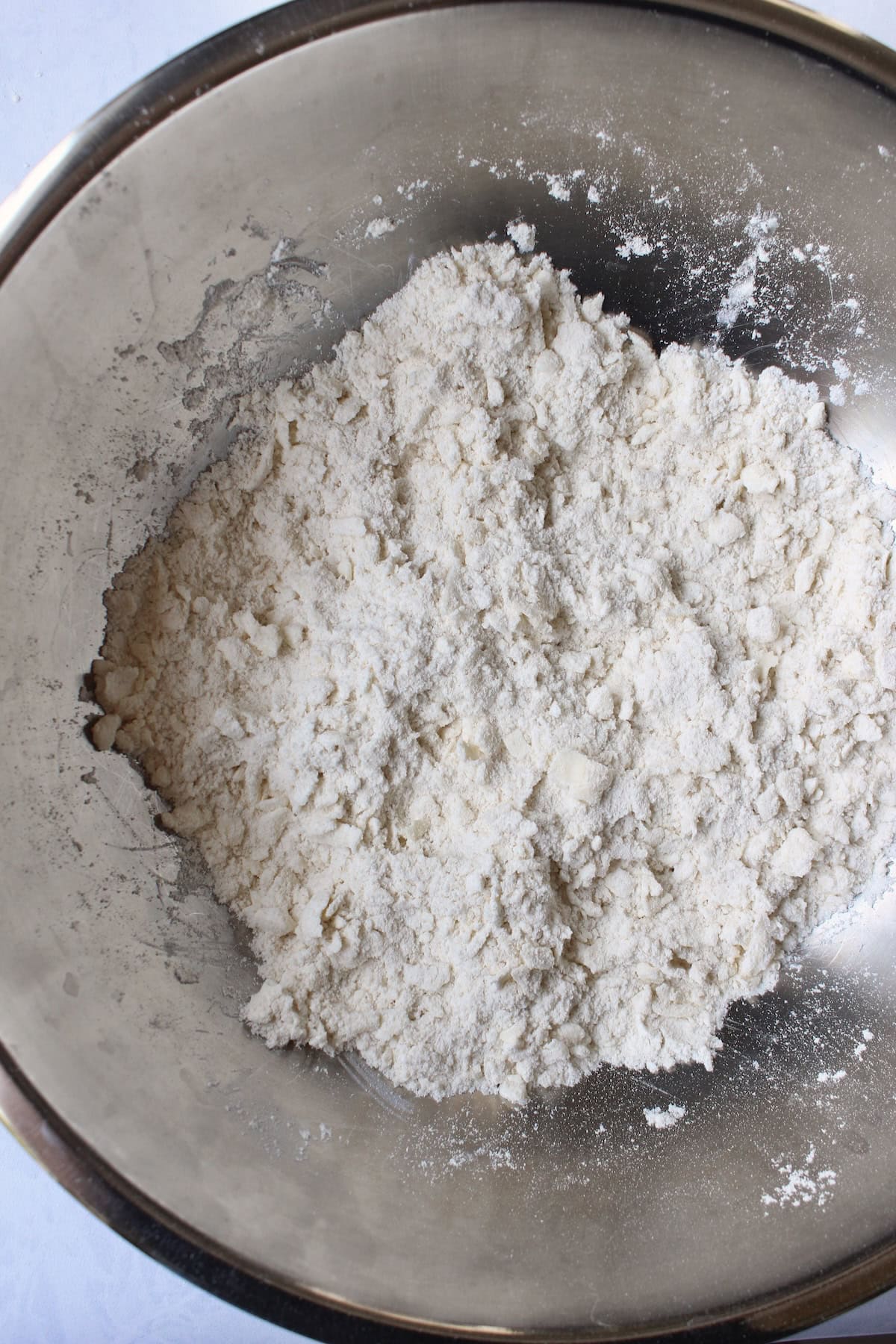 a lumpy flour mixture in a mixing bowl