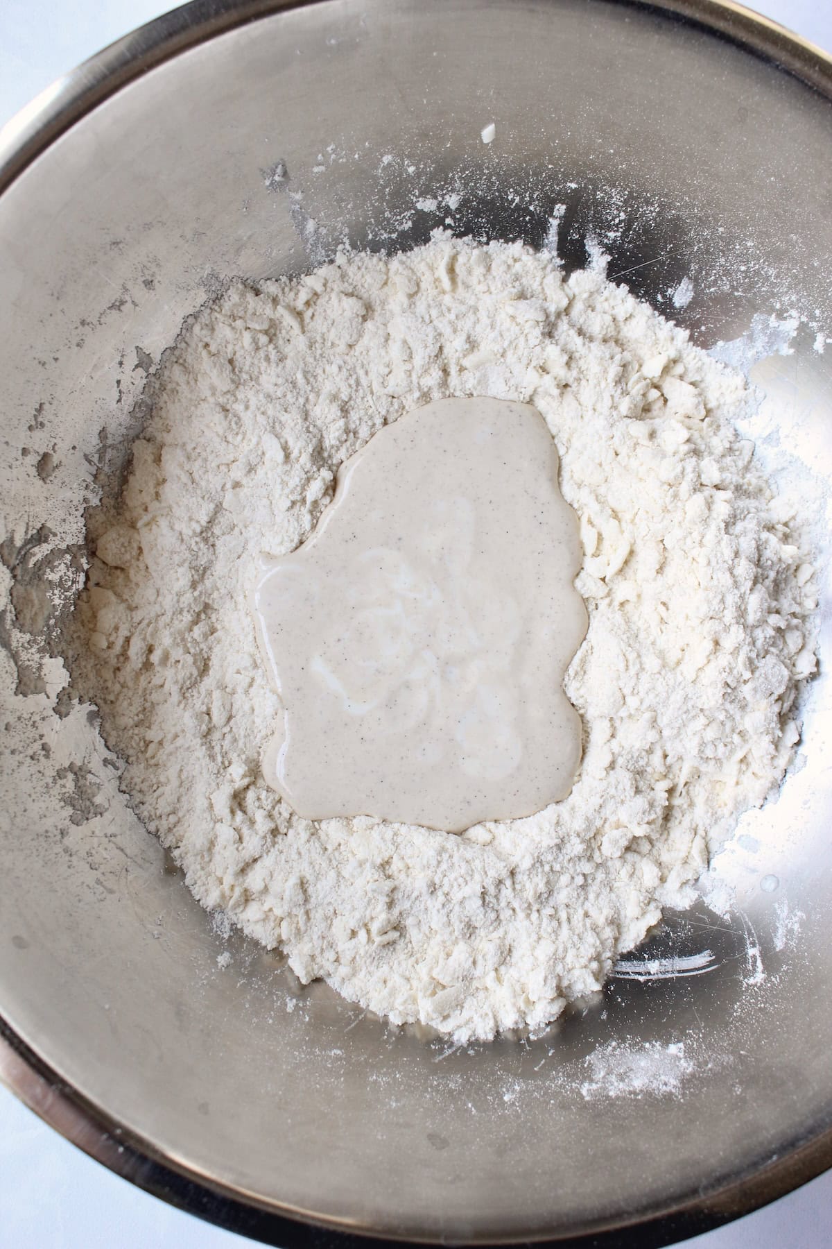 a buttermilk and vanilla mixture is poured into the center of the dough mixture