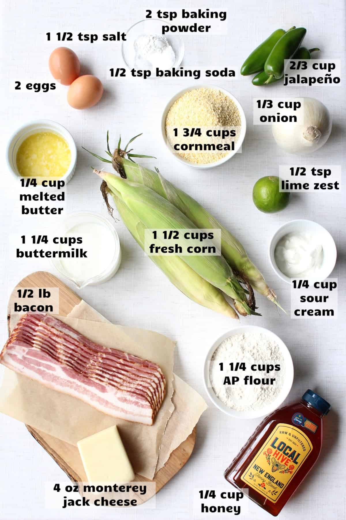 all of the ingredients needed to make jalapeño bacon cornbread are laid out on a work surface and labeled