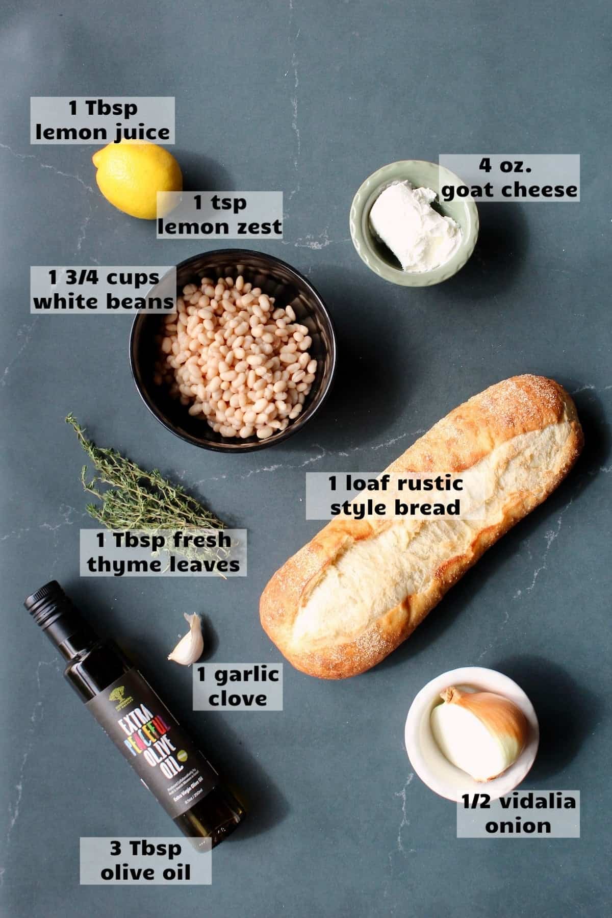 all of the ingredients needed to make white bean bruschetta are laid out on a work surface and labeled